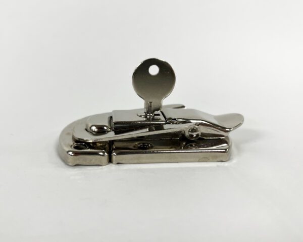 A metal object with a key on top of it.