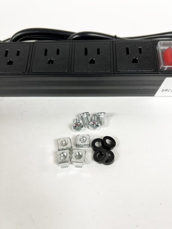 A black power strip with four outlets and six electrical plugs.