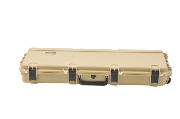 A tan case with black handles and two locks.