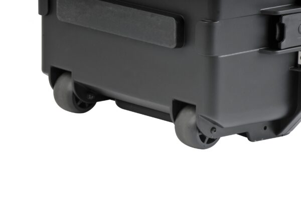 A close up of the wheels on a black case
