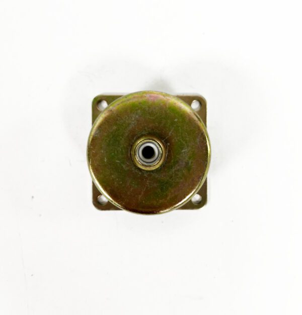 A small metal object sitting on top of a white wall.