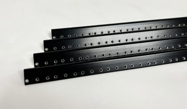 A set of four black strips with holes.